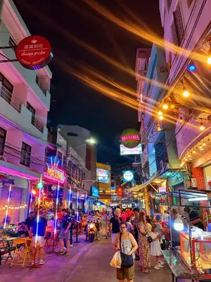 a busy city street at night with people walking around at Chinatown No9 Boutique Hotel in Bangkok