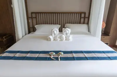 two swans sitting on top of a bed at Chinatown No9 Boutique Hotel in Bangkok