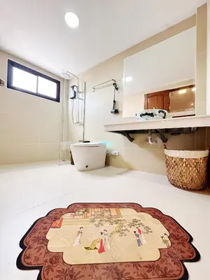 a living room with a rug on the floor at Chinatown No9 Boutique Hotel in Bangkok