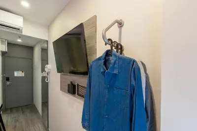 a blue shirt is hanging on a wall at Easy Planet Bangkok Surawong in Bangkok