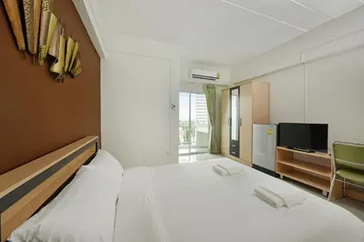 a bedroom with a bed with two phones on it at B32 Apartment in Bangna