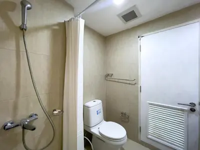 a bathroom with a shower with a toilet and a shower curtain at Near BTS l Fully Furnished l Pool and Gym in Bangkok