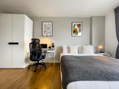 a bedroom with a bed and a desk and a chair at Near BTS l Fully Furnished l Pool and Gym in Bangkok