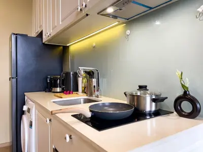 a kitchen with a sink and a bowl on a stove at Near BTS l Large 50 sqm l Luxury facilities l Rooftop Pool in Bangkok