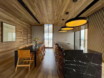 a kitchen with a black counter and wooden walls at Near BTS l Large 50 sqm l Luxury facilities l Rooftop Pool in Bangkok