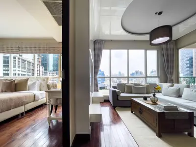 a living room with a couch and a table at 300m BTS l Large 110 sqm l Pool and Sauna in Bangkok