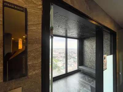 a window in a building with a view of a city at Near BTS l Central Sukhumvit l Pool and Sauna in Bangkok
