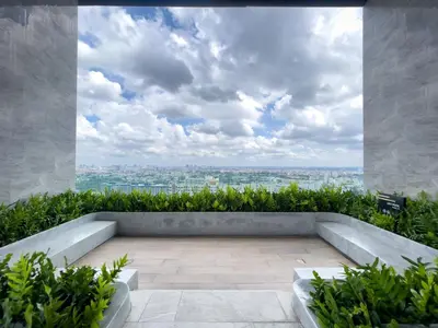 an outdoor patio with a view of the city at Near BTS l Central Sukhumvit l Pool and Sauna in Bangkok