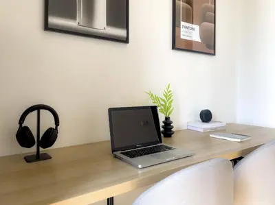 a laptop computer sitting on top of a wooden desk at Near BTS l Central Sukhumvit l Pool and Sauna in Bangkok