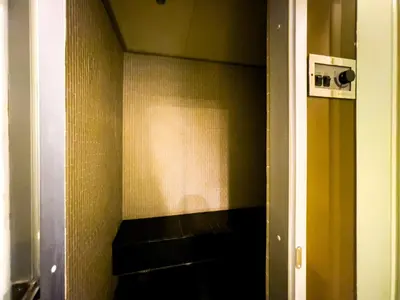a bathroom with a shelf in the corner of a room at Near BTS Asok and MRT SKV l Pool and Sauna in Bangkok