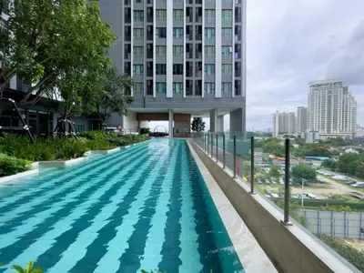 a swimming pool in front of a building at 600 m to BTS l City View l Rooftop Pool in Bangkok