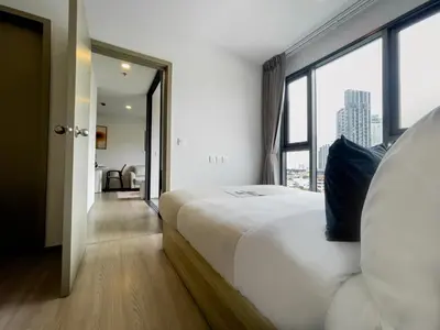 a bedroom with a large bed and a large window at 600 m to BTS l City View l Rooftop Pool in Bangkok