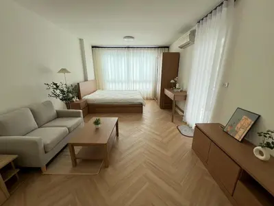 a living room with a couch and a table at Minimal Condo At Ramkhamhaeng 64 in Sathani Ban Hua Mak