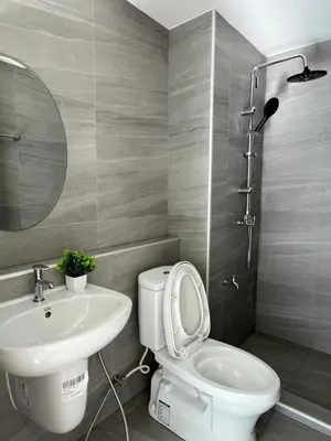 a bathroom with a toilet and a sink at Minimal Condo At Ramkhamhaeng 64 in Sathani Ban Hua Mak