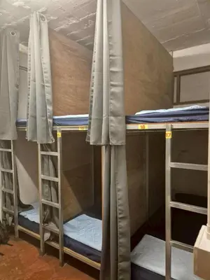 a group of bunk beds in a room at Bangkhunnon Station Hostel in Sathani Thon Buri