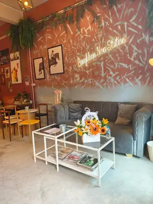a living room with a couch and a table at Bangkhunnon Station Hostel in Sathani Thon Buri