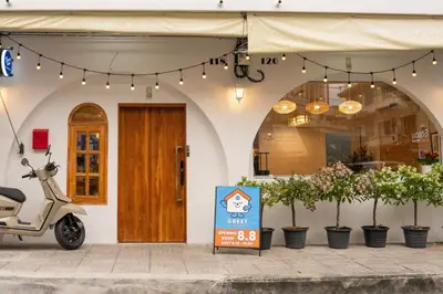 a scooter parked in front of a building with a sign at Greet Hostel & Cafe Samyan in Bangkok