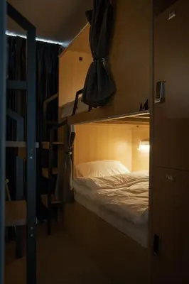 a bedroom with a bunk bed in a room at Greet Hostel & Cafe Samyan in Bangkok