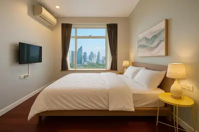 a bedroom with a large bed with a window at Cozy High-Rise Escape in the heart of Bangkok! in Bangkok