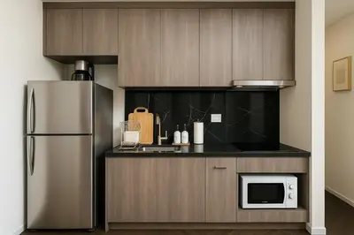 a kitchen with a refrigerator and a microwave at Incredible Loft with High Ceiling in Bangkok