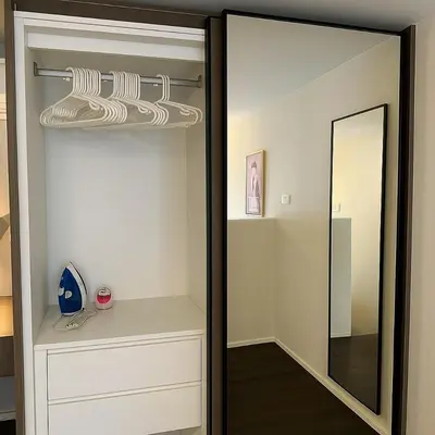 a dressing room with a mirror and a closet at Incredible Loft with High Ceiling in Bangkok