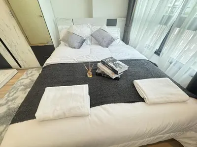 a large white bed with two towels on it at Cozy&Bright apartment -Onnut BTS in Bangkok