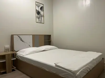 a small bedroom with a bed and a picture on the wall at Siam Place - In the Heart of Bangkok in Bangkok
