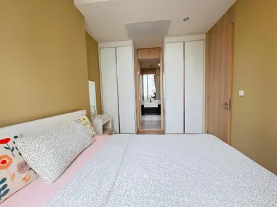 a bedroom with a large bed with two pillows on it at Noble Bangkok Condo in Bangkok