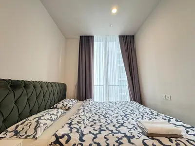 a bedroom with a bed and a large window at Noble Bangkok Condo in Bangkok