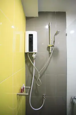 a shower in a bathroom with a soap dispenser at SU 22 in Bangkok