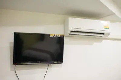 a flat screen tv sitting on a wall at SU 22 in Bangkok