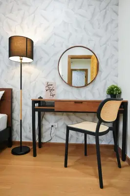 a mirror and a desk with a chair and a lamp at Deluxe Gam-Hom Hostel เจริญนคร in Bangkok