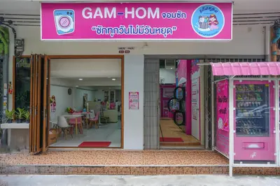 a restaurant with a pink sign on the front of it at Deluxe Gam-Hom Hostel เจริญนคร in Bangkok