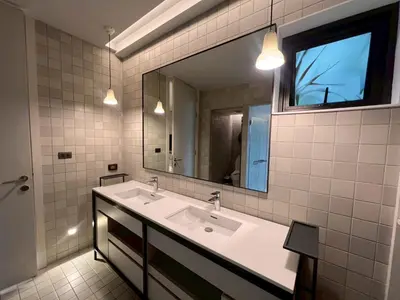 a bathroom with two sinks and a large mirror at Tree Villa Bangkok in Bangkok