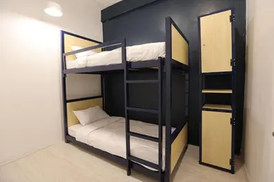 a room with two bunk beds in a room at LCT Hostel Bangkok in Bangkok