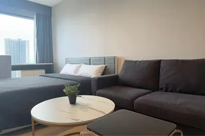 a living room with a couch and a table at Thonglor Next to BTS Modern Condo - Fitness gym with full view in Bangkok