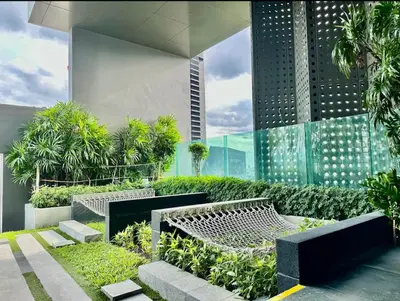 a park with benches and trees and a building at Thonglor Next to BTS Modern Condo - Fitness gym with full view in Bangkok