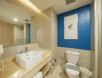 a bathroom with a white toilet and a sink at Aspira Petchkasem in Ban Khlong Om Noi