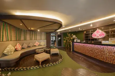 a hotel lobby with a couch and a bar at Aspira Petchkasem in Ban Khlong Om Noi