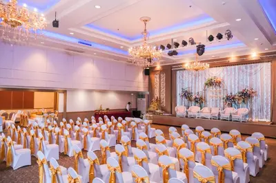 a banquet hall with white chairs and a stage at Aspira Petchkasem in Ban Khlong Om Noi