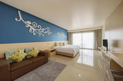 a bedroom with a couch and a bed in a room at Aspira Petchkasem in Ban Khlong Om Noi