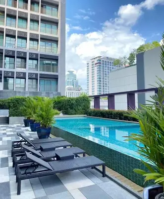 a swimming pool on the roof of a building at Noble Remix Thonglor - Direct BTS Access - Super Fast Wi-Fi in Bangkok