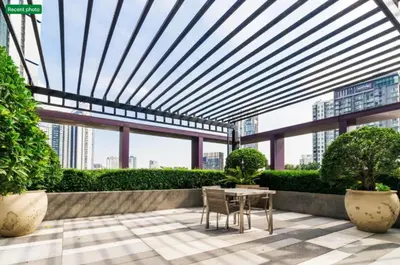a patio with a table and chairs in a building at Noble Remix Thonglor - Direct BTS Access - Super Fast Wi-Fi in Bangkok