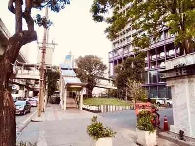 a city street with cars parked on the street at Noble Remix Thonglor - Direct BTS Access - Super Fast Wi-Fi in Bangkok