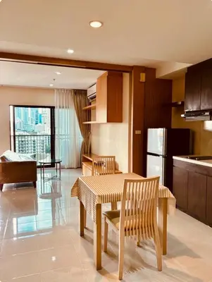 a kitchen with a table and chairs and a refrigerator at Noble Remix Thonglor - Direct BTS Access - Super Fast Wi-Fi in Bangkok