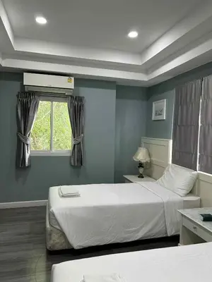 a bedroom with two beds and a window at 101Hotel in Bangkok