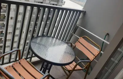 a table and two chairs on a balcony at Manor Riverfront Stay, Chaophraya View Condo, Nonthaburi in Ban Tha It (1)