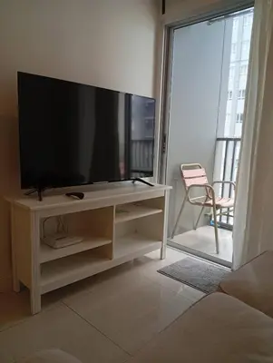 a living room with a flat screen tv on a entertainment center at Manor Riverfront Stay, Chaophraya View Condo, Nonthaburi in Ban Tha It (1)
