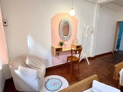 a room with a mirror and a table with a chair at Anne & Tan Stylist Homestay in Bangkok