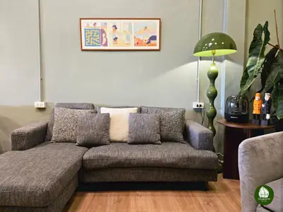 a living room with a couch and a lamp at Obahomu Vacation House for 4-8 pax, 5 min walk to Icon Siam in Bangkok